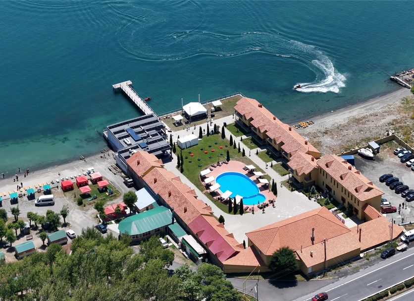 Aerial view of Best Western Bohemian Resort in Sevan with lakeside pool and shoreline