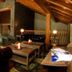 Reserva del Saja Hotel & Spa lounge with leather sofas, wood beams, and stone fireplace in Renedo de Cabuérniga