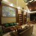 Bali Lovina Beach Cottages lobby with seating, bookshelves and open-air view in Buleleng
