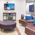 Candlewood Suites Killeen - Fort Hood Area lobby seating area with leather chairs and wall-mounted TV