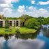 Vacation Village at Bonaventure in Weston with lakeside buildings and lush greenery