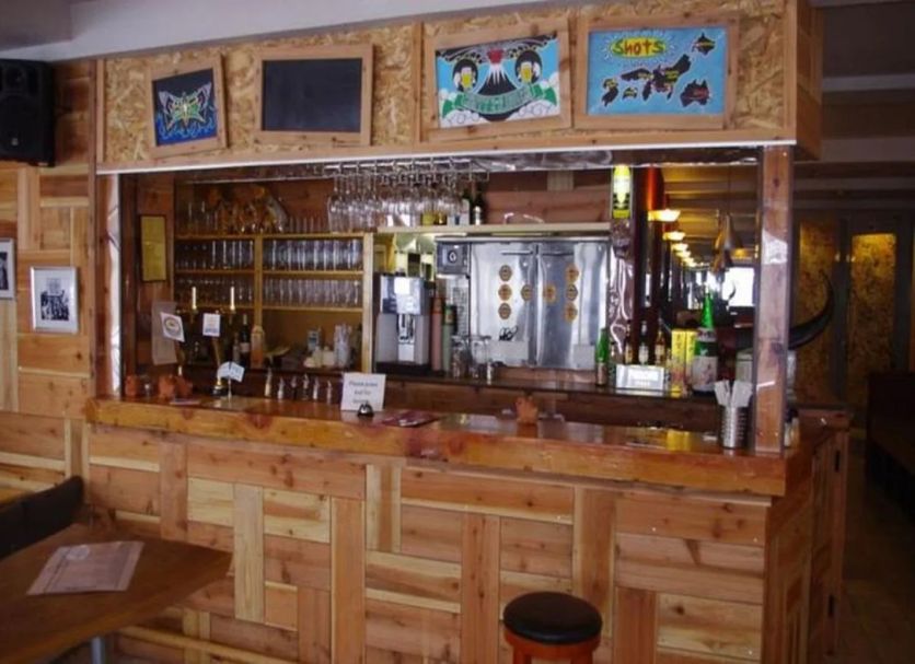 Hakuba Gondola Hotel bar area with wooden counter and stools in Hakuba