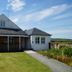 Hillhead Farm Lets in Stirling with a grassy lawn, gravel path, and countryside views