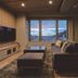 Kowakuen Haruka in Matsuyama guest room with sofa, beds, and large window with mountain view