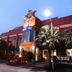 The Loom Rangsit hotel exterior in Pathum Thani at dusk with fountain and palm trees