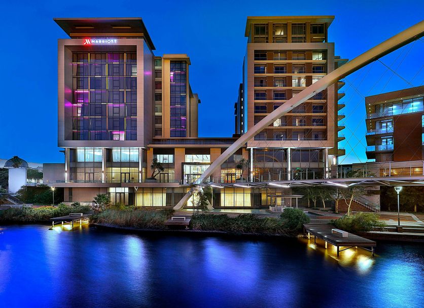 Cape Town Marriott Hotel Crystal Towers at dusk beside a reflective waterway and modern towers in Cape Town