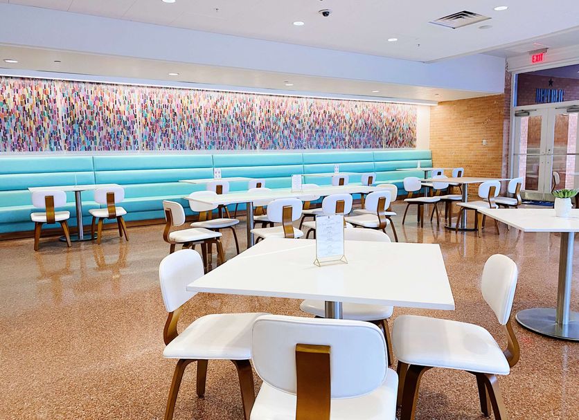 The Fredonia Hotel in Nacogdoches lobby dining area with turquoise banquettes and white tables