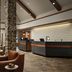 Inn at Bellefield in Hyde Park lobby with stone columns, front desk, and leather seating
