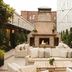 Emeline Charleston courtyard with outdoor sofas and a brick fireplace under string lights
