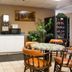 Breakfast area at Scottish Inn Downtown Jacksonville in Jacksonville with coffee station, tables, and vending machine.