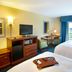 Hampton Inn & Suites Lake Wales guest room with two beds, desk, TV, and window view