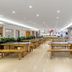 Xiamen Junming Hotel in Xiamen dining hall with long wooden tables and bright windows