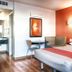 Motel 6 Mammoth Lakes guest room with bed, table seating, and bathroom entrance