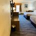 Quality Inn Danville - University Area guest room with two beds, TV, desk and seating area