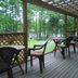 Cafe & Inn That Sounds Good in Semboku: covered wooden terrace with tables and chairs overlooking trees