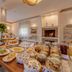 Hotel Massimo in Cecina breakfast buffet with pastries, fruit, and jars of yogurt by a fireplace