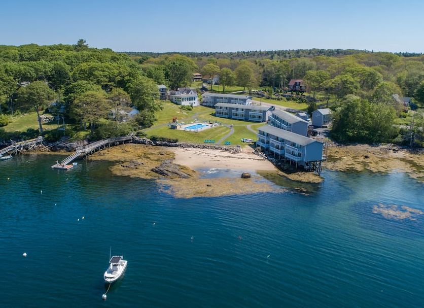 Smuggler's Cove Inn in East Boothbay overlooking a rocky waterfront with a small beach and dock