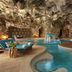 Dreams Natura Resort & Spa in Puerto Morelos indoor cave pool with curving lagoon-style water and loungers