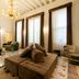 Hotel Villa Soligo lounge with tufted seating, tall windows and chandelier in Farra di Soligo
