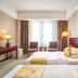 Adange Hotel Lijiang guest room with two twin beds and window seating