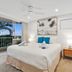 Noosa Hill Resort in Noosa Heads bedroom with balcony, tropical view, and king bed