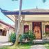 Mirah Hotel & Resort Banyuwangi traditional resort villa with ornate wooden doorway and tropical garden