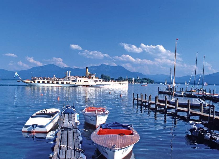 Hotel Schmelmer Hof in Bad Aibling with lakeside boats, pier, and mountain views