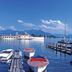Hotel Schmelmer Hof in Bad Aibling with lakeside boats, pier, and mountain views