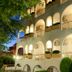 Kronos Hotel in Platamon with illuminated arched balconies and landscaped exterior at night
