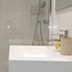 Hotel San Nikolas Sea Views bathroom with glass shower, sink vanity and wall-mounted shower fixture in Hondarribia