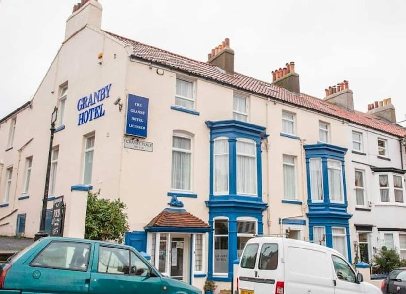 Granby Hotel in Scarborough exterior with blue-trimmed bay windows and parked cars