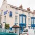 Granby Hotel in Scarborough exterior with blue-trimmed bay windows and parked cars