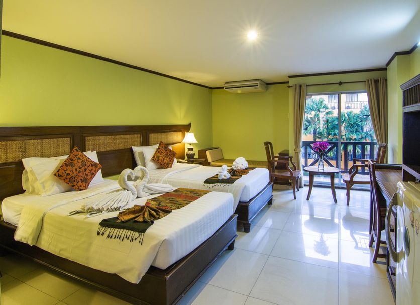 Phuphaya Resort Pattaya in Pattaya guest room with twin beds, balcony view, desk and TV