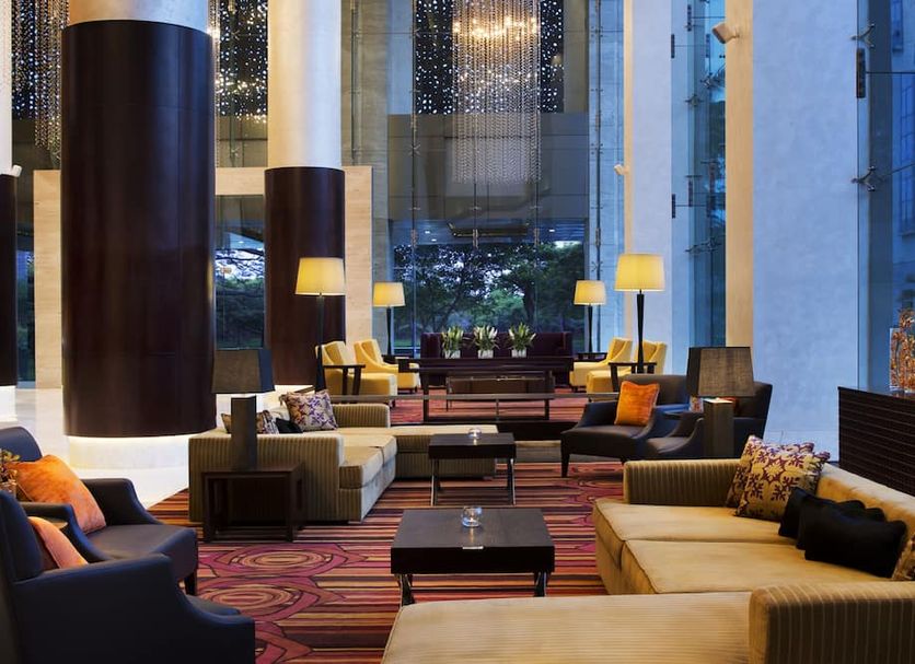 JW Marriott Hotel Bengaluru lobby with tall windows, lounge seating, and city views
