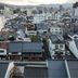 Hotel Ikedaya in Matsumoto with city rooftops and distant mountains at sunset