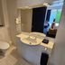 U Studios Paraparaumu, SureStay Collection by Best Western bathroom with toilet, sink, mirror and tiled floor