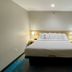 Days Inn by Wyndham Jefferson City guest room with a queen bed and bedside lamps