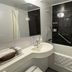 Kakogawa Plaza Hotel bathroom with sink, mirror, bathtub and black glass shower wall in Kakogawa