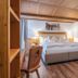 Hotel Englhof, Zell am Ziller: cozy guest room with double bed, wooden ceiling, desk and chair