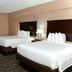Cobblestone Inn & Suites - Denison guest room with two queen beds and TV in Denison