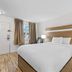MainStay Suites Knoxville - Cedar Bluff guest room with queen bed, bedside lamps, and window in Farragut