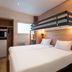 Kyriad Eco Lille Sud - Noyelles Godault bunk-bed room with compact kitchenette and double bed