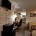 Country Inn Beaver guest room with two beds, wall-mounted TV, desk, and bathroom vanity view