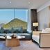 Wonderland Hotel Luxury, Hangzhou suite with bay window mountain view and blue sectional seating