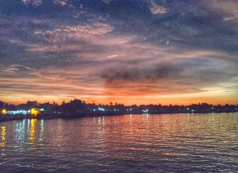 Ziegler Cottage, Negombo waterfront sunset view over calm water and distant lights
