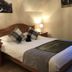 Ben Nevis Guest House in Fort William bedroom with double bed, bedside lamps, and plaid pillows