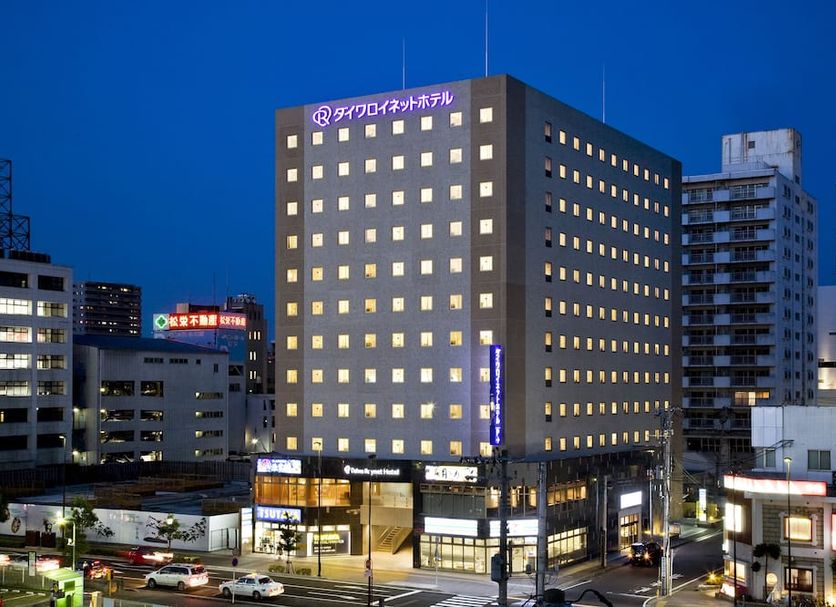 Daiwa Roynet Hotel Sendai in Sendai at night with lit windows and street-level shops