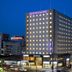 Daiwa Roynet Hotel Sendai in Sendai at night with lit windows and street-level shops
