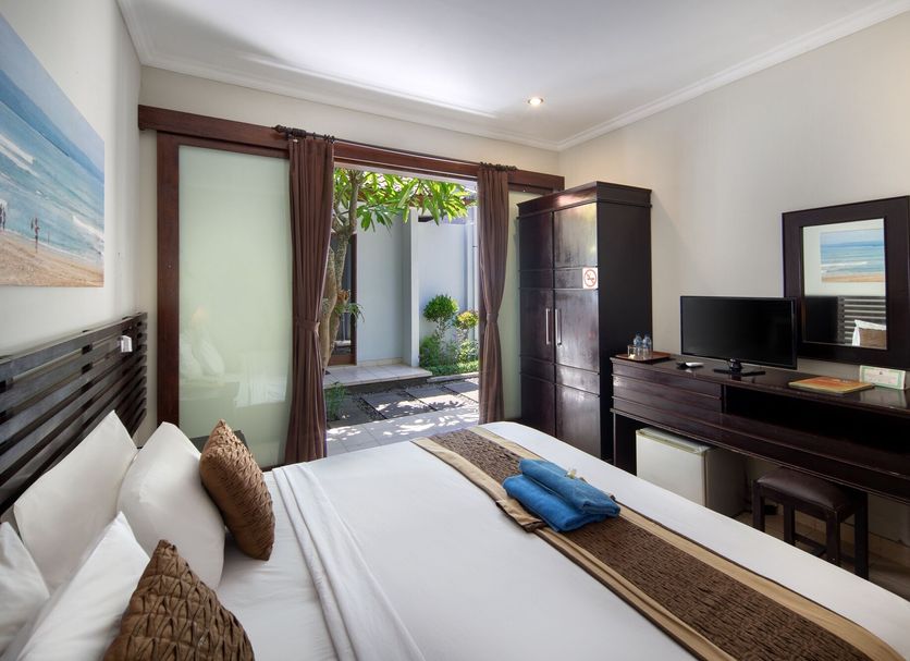 Legian Village Beach Resort in Kuta guest room with patio doors to a courtyard and vanity desk