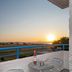 Oasis Tigaki terrace table and chairs with sunset sea view in Tigaki